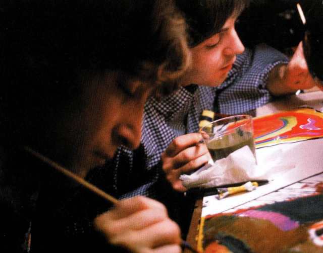 John Lennon and Paul McCartney painting a canvas